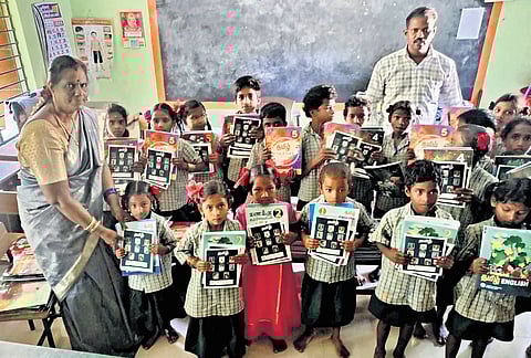 HM Saraswathi with her students in Kurumalai after delivering new books she carried up the hill