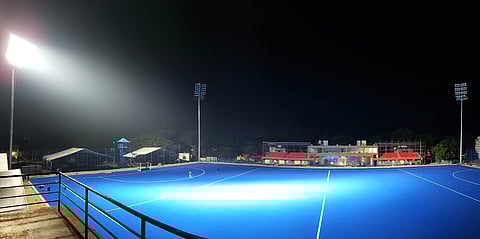 Flood lights illuminate the hockey ground in the MGR stadium
