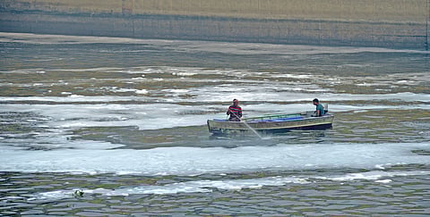 Delhi Jal Board workers spraying chemicals in Yamuna River to control the foams at Kalindi Kunj.