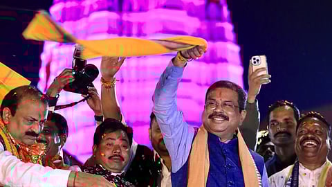 Dharmendra Pradhan waves a gamcha during a rally on Sunday