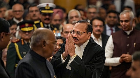 Newly sworn-in Chief Justice of India Surya Kant greets the gathering during a ceremony, at Rashtrapati Bhavan in New Delhi, Monday, Nov. 24, 2025. Former President Ram Nath Kovind looks on.
