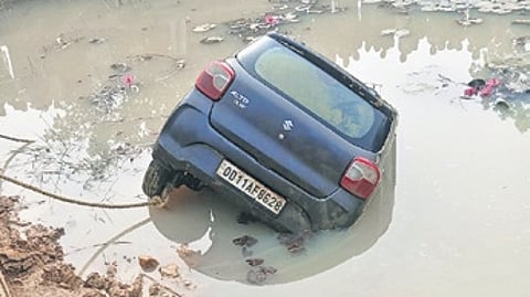 The car being pulled out of the pond