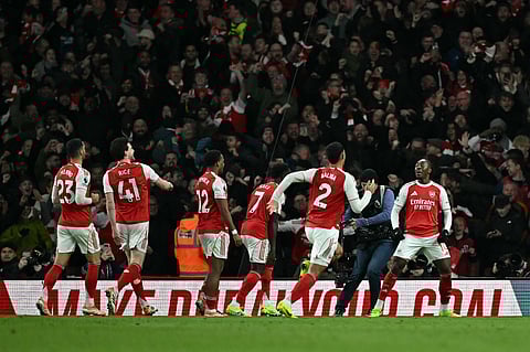 Arsenal's Eberechi Eze (R) celebrates scoring his team's second goal during the English Premier League football match between Arsenal and Tottenham Hotspur at the Emirates Stadium in London on November 23, 2025.