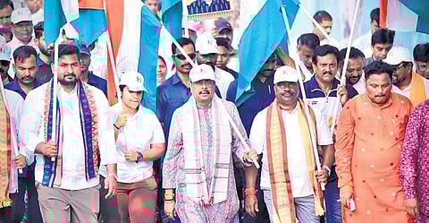 Pradhan with ministers Suryabanshi Suraj and Rabi Narayan Naik leading the march