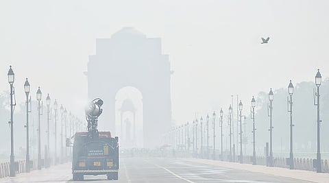 An anti-smog gun on a multi-purpose vehicle sprays water droplets to curb air pollution at Kartavya Path, in New Delhi.