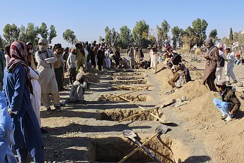 Locals prepare graves for victims of an overnight attack on a home that, according to an Afghan government spokesman, was carried out by Pakistan.