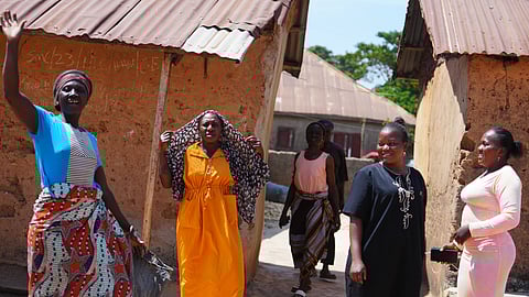 A woman and others who were kidnapped during a church service in November 2024 waves outside her house in Kaduna, northwestern Nigeria, Nov. 6, 2025.