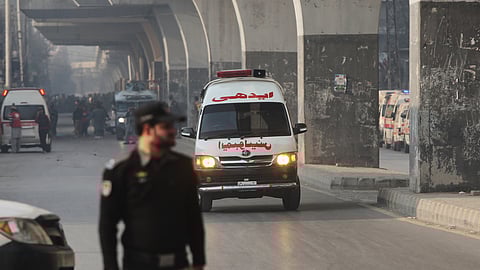 An ambulance carrying injured people drive towards a hospital after suicide bombers attacked the headquarters of the Federal Constabulary (FC), in Peshawar, Pakistan, Monday, Nov. 24, 2025