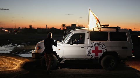 Red Cross convoy carrying the remains of a person believed to be a deceased hostage handed over by Gaza militants makes its way toward the border crossing with Israel, to be transferred to Israeli authorities, in Deir al-Balah, central Gaza Strip, Tuesday, Nov. 25, 2025
