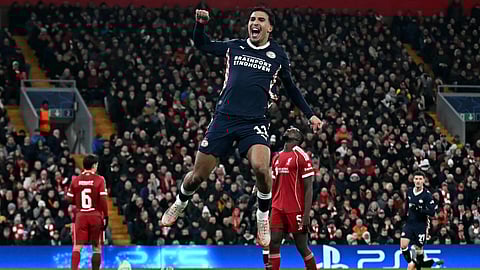 PSV Eindhoven's Couhaib Driouech (C) celebrates scoring his team's third goal during the UEFA Champions League league phase football match between Liverpool and PSV Eindhoven at Anfield in Liverpool, on November 26, 2025.