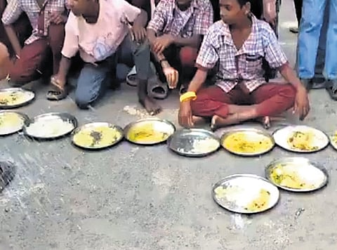 Students of Government Zilla Parishad School, Koutala mandal, stage a demonstration, displaying food served as midday meal