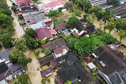 This aerial shot taken using a drone shows a flooded neighborhood in Medan, North Sumatra, Indonesia, Friday, Nov. 28, 2025.