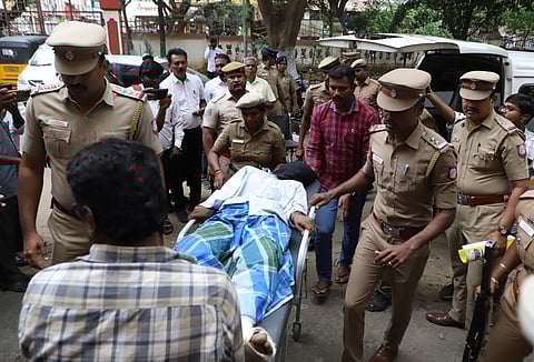 Suspects in Coimbatore airport gang-rape case brought to court on stretchers after police shootout injuries.