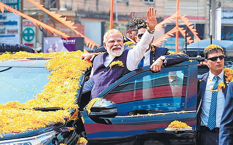 Prime Minister Narendra Modi takes out a road show in Udupi on Friday. Thousands of people lined the streets from Bannanje Circle to Kalsanka Junction to greet him.