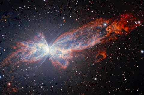 This image provided by NSF NOIRLab shows NGC 6302, a billowing planetary nebula that resembles a cosmic butterfly.