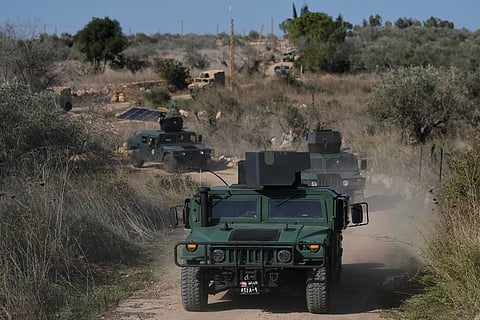 A convoy of Lebanese army vehicles drives near the border with Israel in the village of Alma al-Shaab during a Lebanese army media tour in south Lebanon.