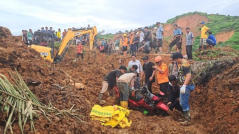 In this photo released on Saturday, Nov. 29, 2025, by the Indonesian National Search and Rescue Agency (BASARNAS), rescuers remove a scooter buried in the mud as they search for victims at a village hit by a landslide in Batu Goading, North Sumatra, Indonesia.