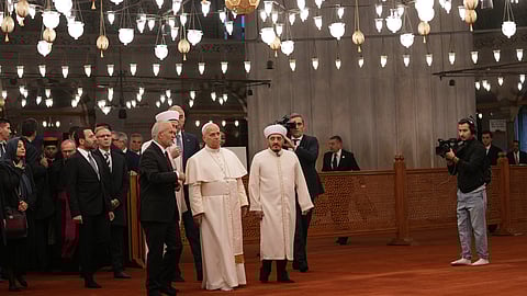Pope Leo XIV, center, walking with Muezzin Musa Asgın Tunca, left, Dr. Emrullah Tuncel, second from left, and Imam of Mosque Sultanahmet Fatih Kaya, visits the Sultan Ahmed Mosque in Istanbul, Saturday, Nov. 29, 2025.