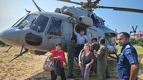 In this image posted on Nov. 30, 2025, Indian Air Force personnel evacuate stranded passengers from cyclone-hit Sri Lanka.