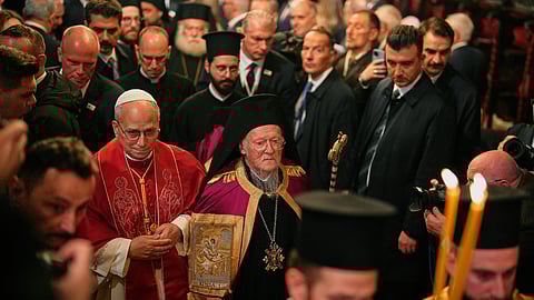 Pope Leo XIV and Ecumenical Patriarch Bartholomew I, the spiritual leader of the world's Eastern Orthodox Christians, leave after attending the Doxology at the Patriarchal Church of Saint George, in Istanbul, Turkey, Saturday, Nov. 29, 2025.