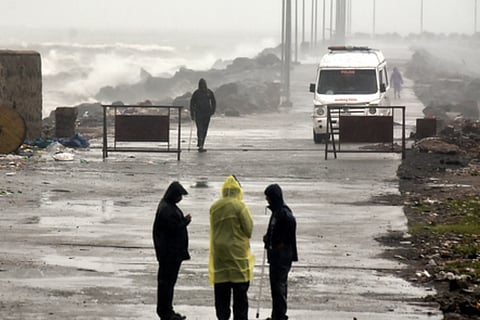 Police stand guard on NH4, preventing the public from entering. Shots show the impact of Cyclone Ditwah at Ennore and Kasimedu.
