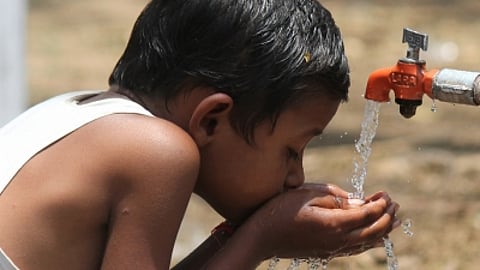 Young boy drinking water from a tap. Image used for representational purposes only.