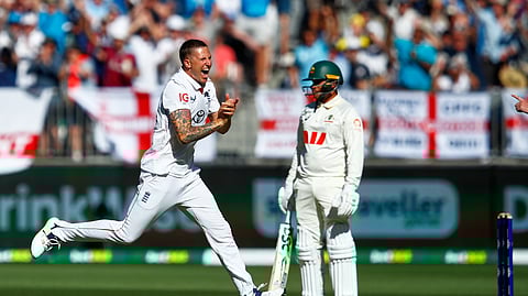 England's Brydon Carse celebrates the wicket of Australia's Usman Khawaja, right, during the first Ashes cricket test match between Australia and England in Perth, Friday, Nov. 21, 2025.