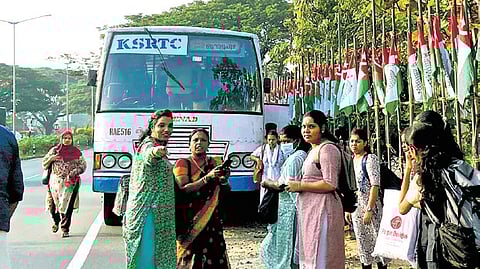 Passengers wait for another ride after the KSRTC bus they were travelling in broke down at Nettoor Junction.