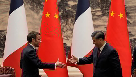 French President Emmanuel Macron, left, shakes hands with Chinese President Xi Jinping after meeting the press at the Great Hall of the People in Beijing on April 6, 2023.