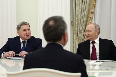 Russian President Vladimir Putin, right, and Russian Presidential foreign policy adviser Yuri Ushakov, left, attend talks with U.S. special envoy Steve Witkoff, back to a camera, at the Senate Palace of the Kremlin in Moscow, Russia, Tuesday, Dec. 2, 2025.