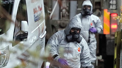 FILE - Personnel in protective gear work on a van in Winterslow, England, March 12, 2018, as investigations continue into the nerve-agent poisoning of former Russian intelligence officer Sergei Skripal and his daughter Yulia