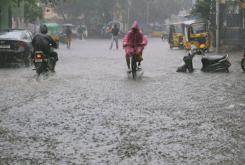 People seen on the rain and flood at Thana street in Purasaiwalkam