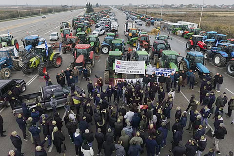 Farmers and protesters block a highway at the Malgara toll stations near Thessaloniki, norther Greece, on Wednesday, Dec 3, 2025, during a protest over delays in farm subsidy payments.