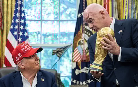 FIFA president Gianni Infantino (R) hands the World Cup trophy to US President Donald Trump in the Oval Office of the White House in Washington DC. (Photo | AFP)