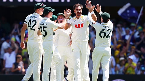 Australia's Mitchell Starc, centre, celebrates with teammate the wicket of England's Ben Duckett during the second Ashes cricket test match between Australia and England in Brisbane, Thursday, Dec. 4, 2025.