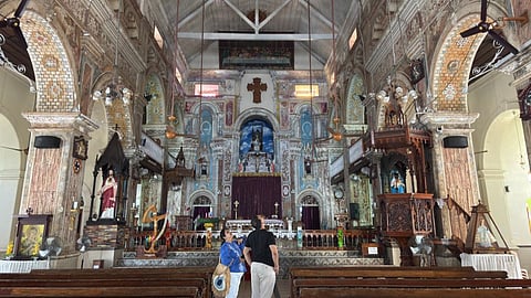 Tourists admire the intricate murals of Santa Cruz Basilica in Fort Kochi