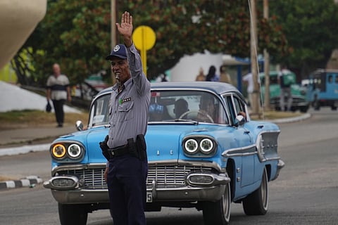 A National Police officer directs traffic due to a power outage in Havana, Cuba, Wednesday, Dec 3, 2025.