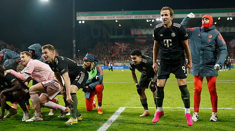 Bayern Munich's #09 Harry Kane (2R) celebrates with teammates and fans after the German Cup (DFB-Pokal) round of 16 football match between 1 FC Union Berlin and FC Bayern Munich in Berlin on December 3, 2025.