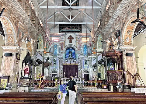 Tourists admire the intricate murals of Santa Cruz Basilica in Fort Kochi