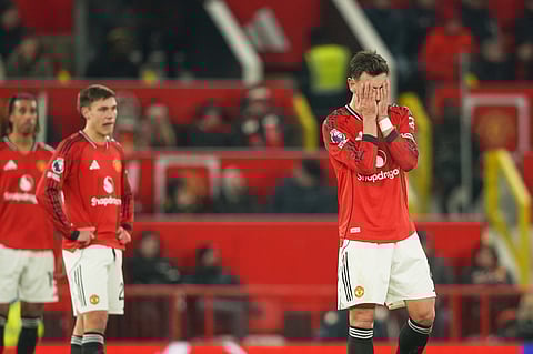Manchester United's Bruno Fernandes, right, reacts after West Ham's Soungoutou Magassa scored his side's first goal during the EPL soccer match between Manchester United and West Ham United on Dec. 4, 2025.