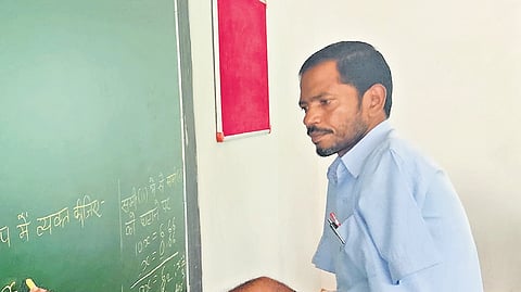 Each day, Gulshan enters his classroom with unwavering spirit, gripping chalk between his toes to teach mathematics on the blackboard.