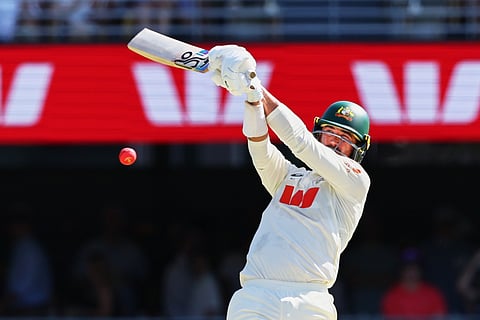 Australia's Mitchell Starc plays a shot during the second Ashes cricket test match between Australia and England in Brisbane, Saturday, Dec. 6, 2025.