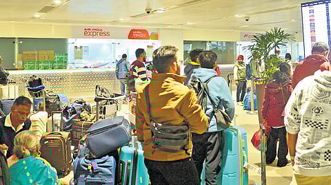 Passengers wait in a queue at T1 of the IGI Airport on Saturday. The domestic carrier has cancelled several flights.