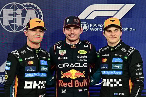 (From L-R) McLaren's British driver Lando Norris. Red Bull Racing's Dutch driver Max Verstappen, and McLaren's Australian driver Oscar Piastri pose for a picture after the qualifying session ahead of the Abu Dhabi Formula One Grand Prix.