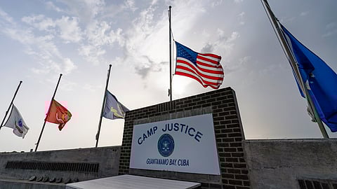 In this photo reviewed by US military officials, flags fly at half-staff at Camp Justice, Aug. 29, 2021, in Guantanamo Bay Naval Base, Cuba.