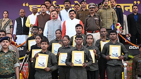 10 Maoists who surrendered on December 7, 2025, handover their arms to Madhya Pradesh Chief Minister Mohan Yadav at an even in Balaghat.