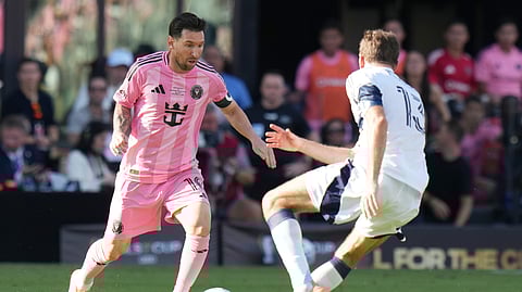 Inter Miami forward Lionel Messi (10) runs with the ball as Vancouver Whitecaps forward Thomas Müller (13) defends during the first half