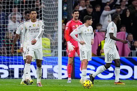 Real Madrid's Jude Bellingham, left, and teammates react after Celta's Williot Swedberg scored his side's second goal during the Spanish La Liga soccer match between Real Madrid and Celta Vigo in Madrid, Spain, Sunday, Dec. 7, 2025.