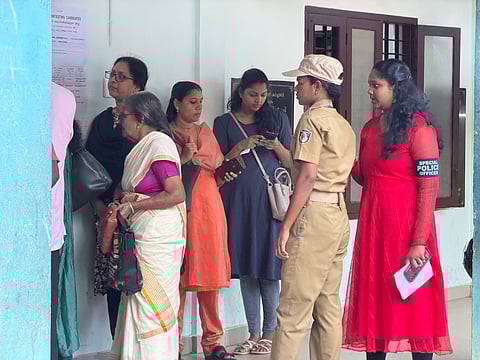 Police personnel on duty facilitate an elderly woman voter to get priority in the queue at Kachani ward of Thiruvananthapuram Corporation on Tuesday, Dec 9, 2025.