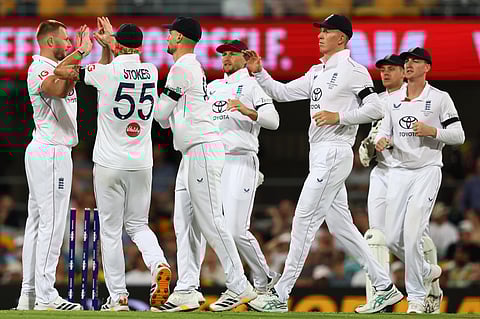 England's players celebrate the wicket of Australia's Travis Head during the second Ashes cricket test match between Australia and England.